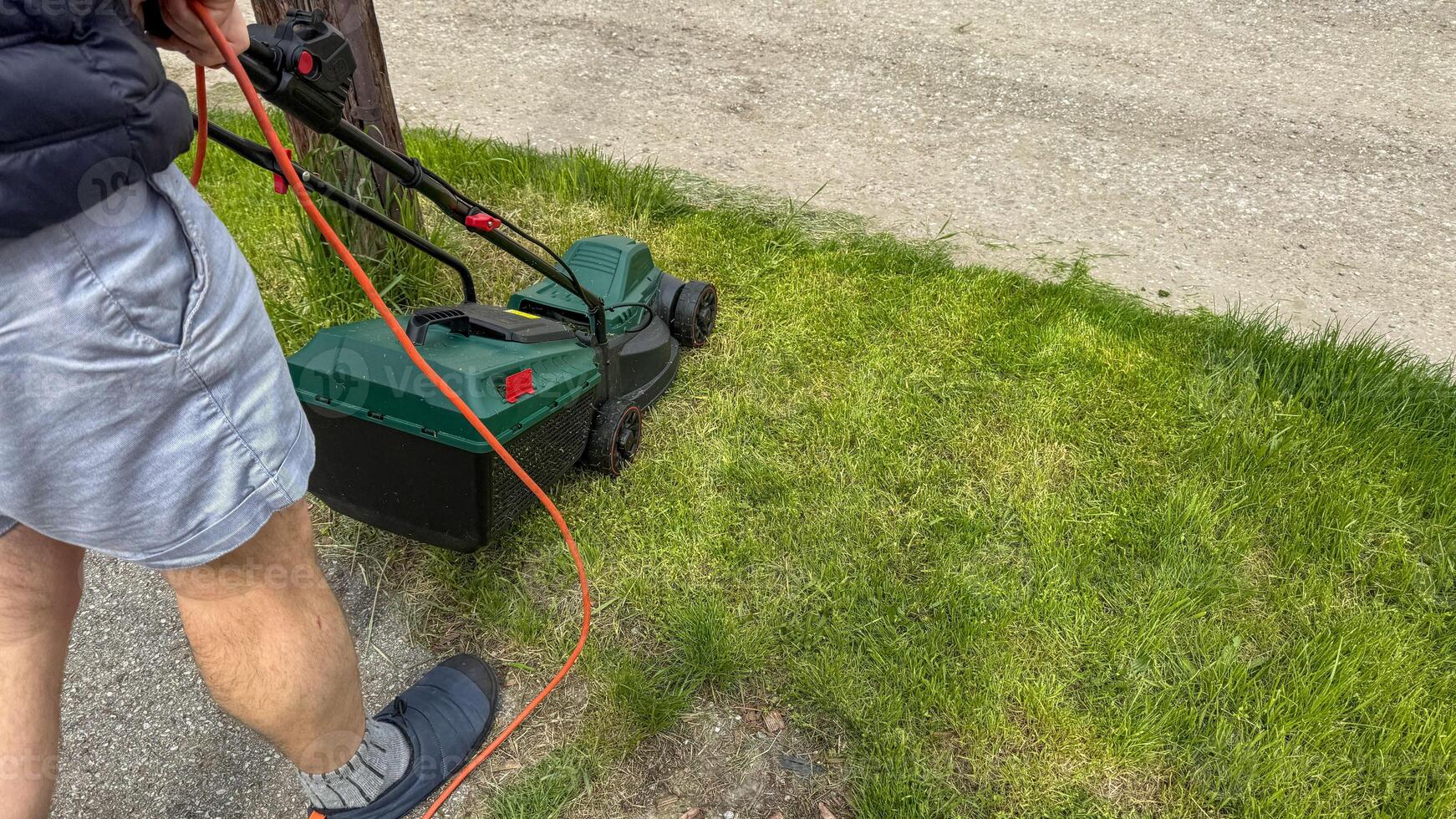 Sunlit suburban ritual, pale skinned man mowing lawn, whispers of Green Thumb Day, celebrating verdant tranquility in eco urban spaces photo