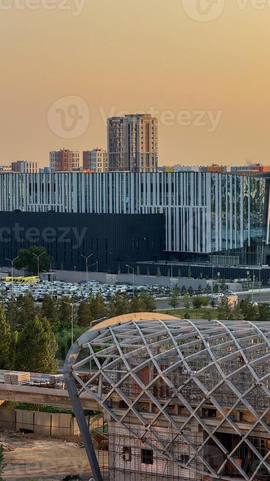 Futuristic urban skyline at sunset, architectural harmony with geometric patterns, celebrates World Architecture Day and Solar Appreciation Month photo