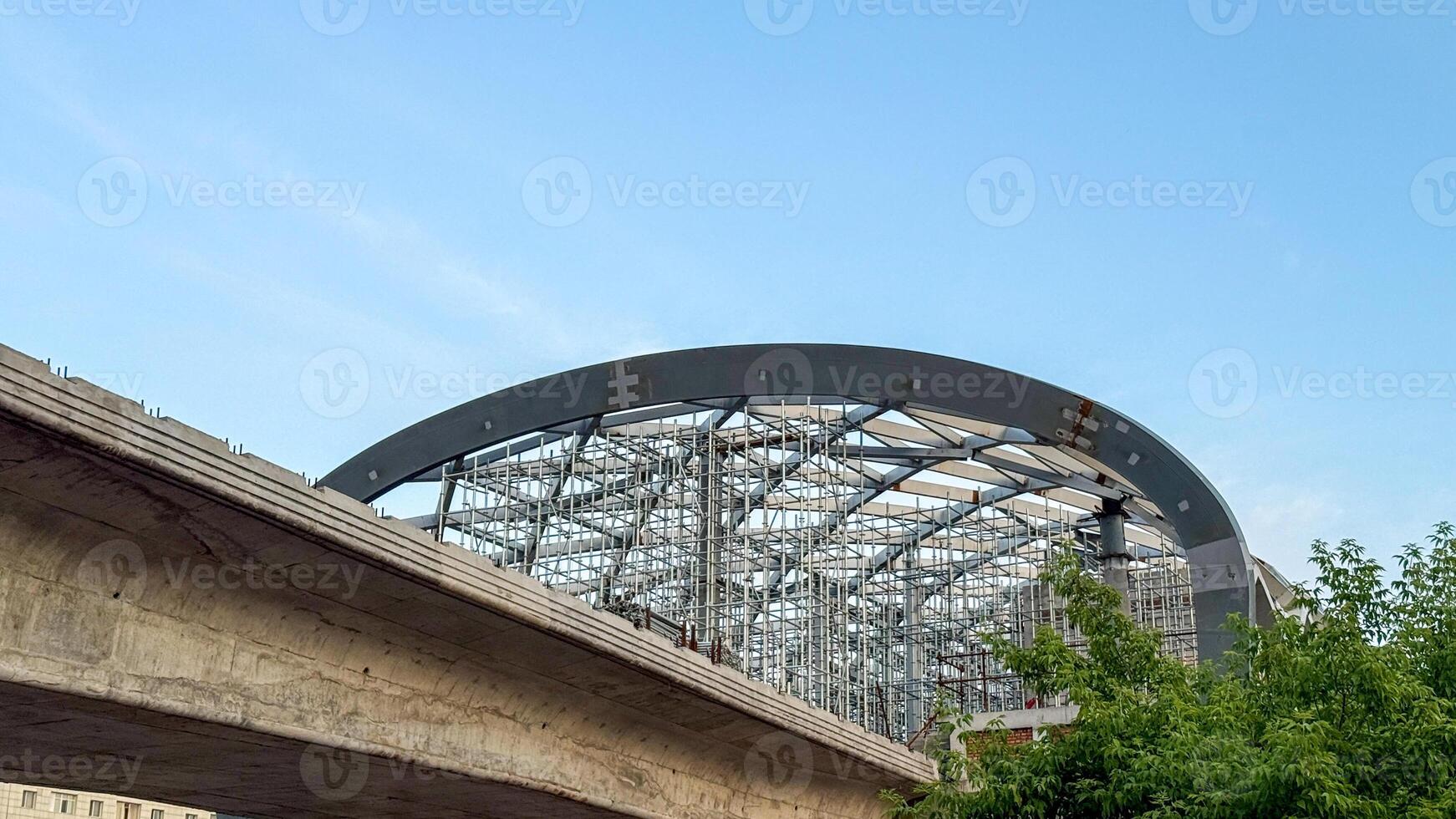 Surreal steel cathedral arches loom, hugging azure skies, an homage to brutalist daydreams and urban architecture festivals photo