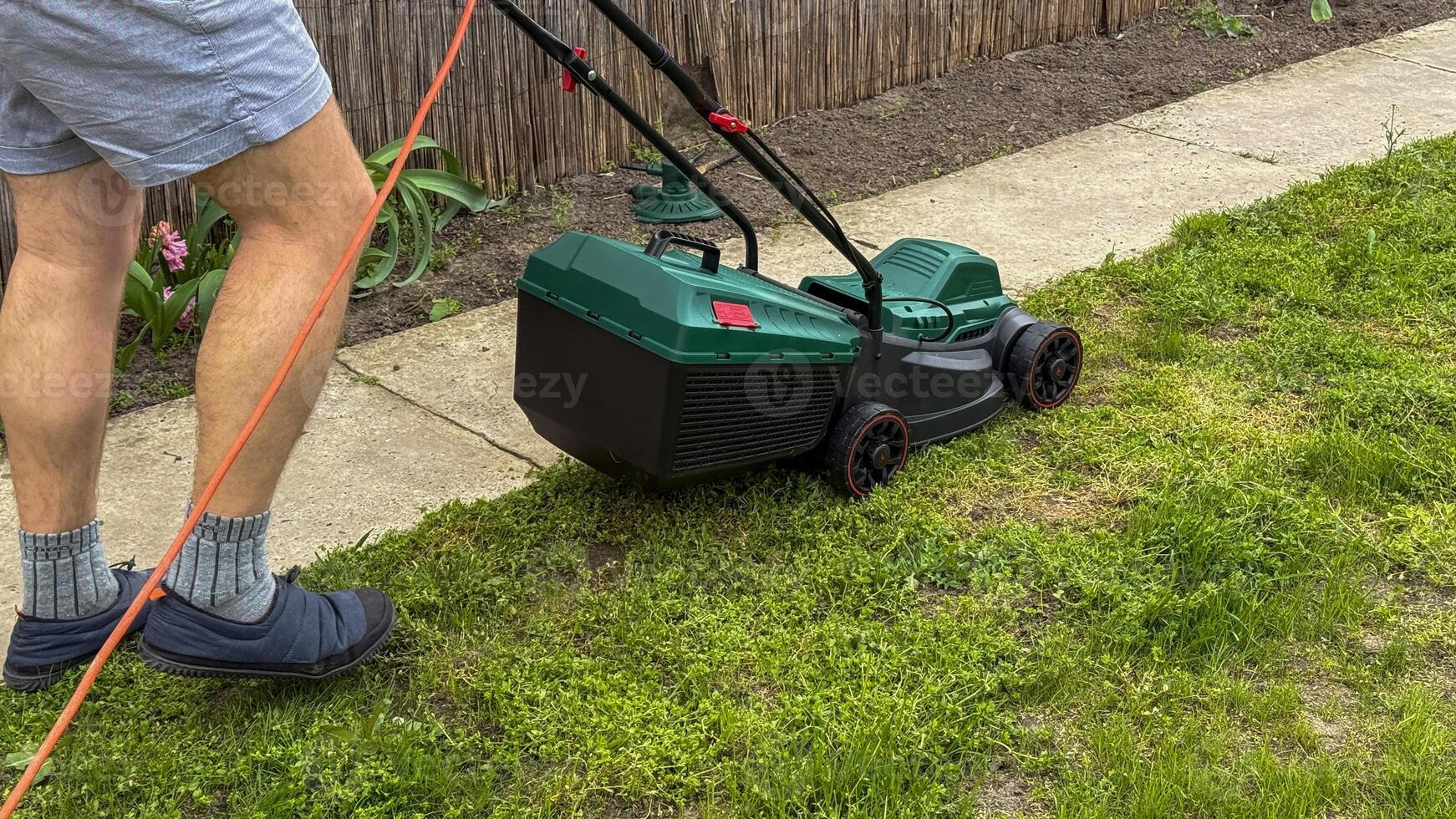 A Caucasian male diligently mows an emerald lawn, capturing the essence of Earth Day and Neighbor Day harmony photo