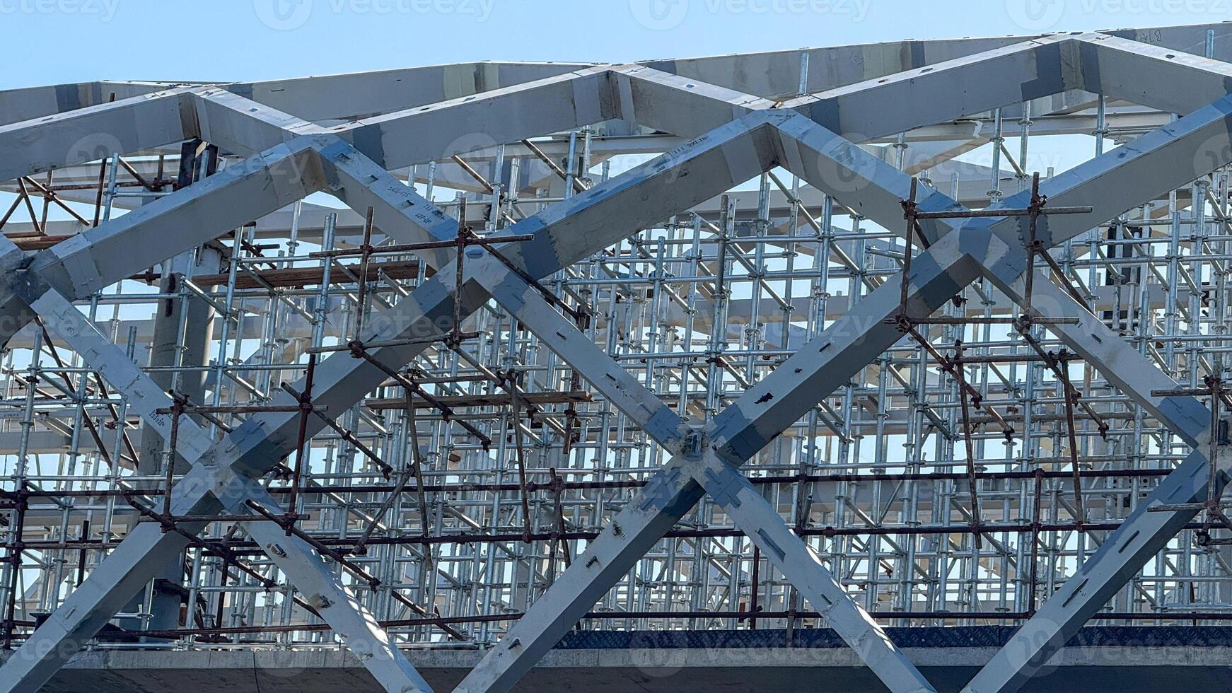 Intricate lattice of iron beams echoes urban metamorphosis, capturing International Workers Day spirit and architectural labyrinthine dreams photo