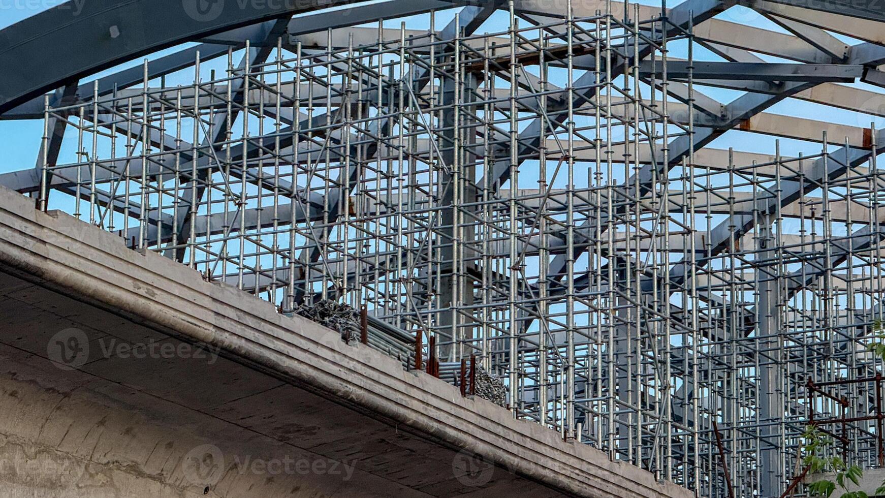 Steel beams interlace like metallic spider webs, capturing urban growth during Skyscraper Day under a skyward promise architecture photo
