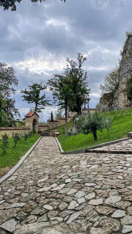 Ancient stone path meanders through mystical castle garden whispers, echoing medieval daydreams, perfect for World Heritage Day wanderlust photo