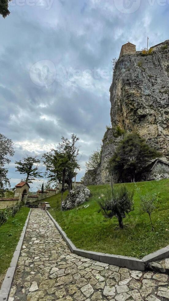 Ancient fortress perched on towering rock under brooding skies, perfect for National Fortress Day and Pathfinders Mythic Journey photo