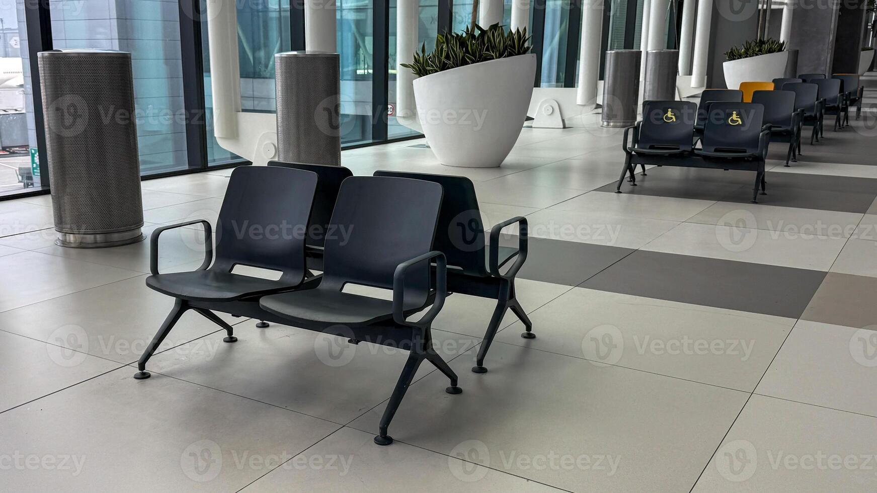 Silent airport seating echoes anticipation, whispers of journey stories and International Civil Aviation Day wanderlust, where dreams await departure photo