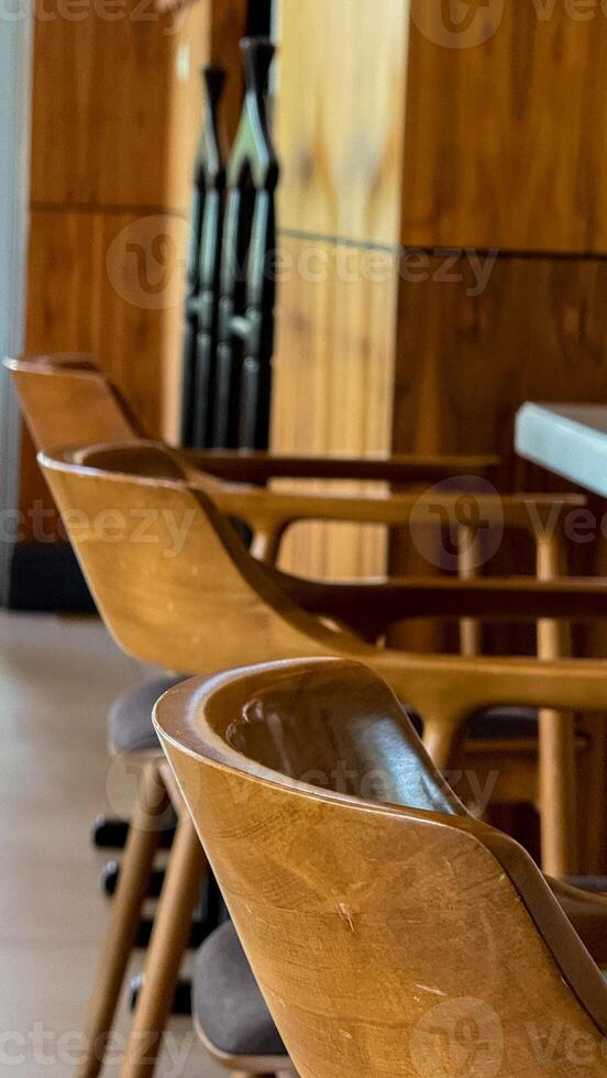Polished oak chairs bask in midday glow, echoing whispers of hygge gatherings and rustic serenity in Nordic cafes photo