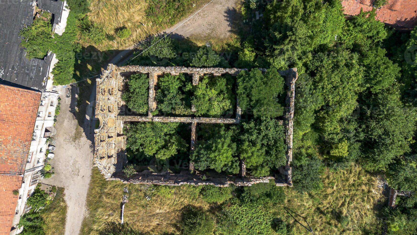Half-ruined ancient castle German building in Poland, Mietkow, Borzygnev. Drone view. photo