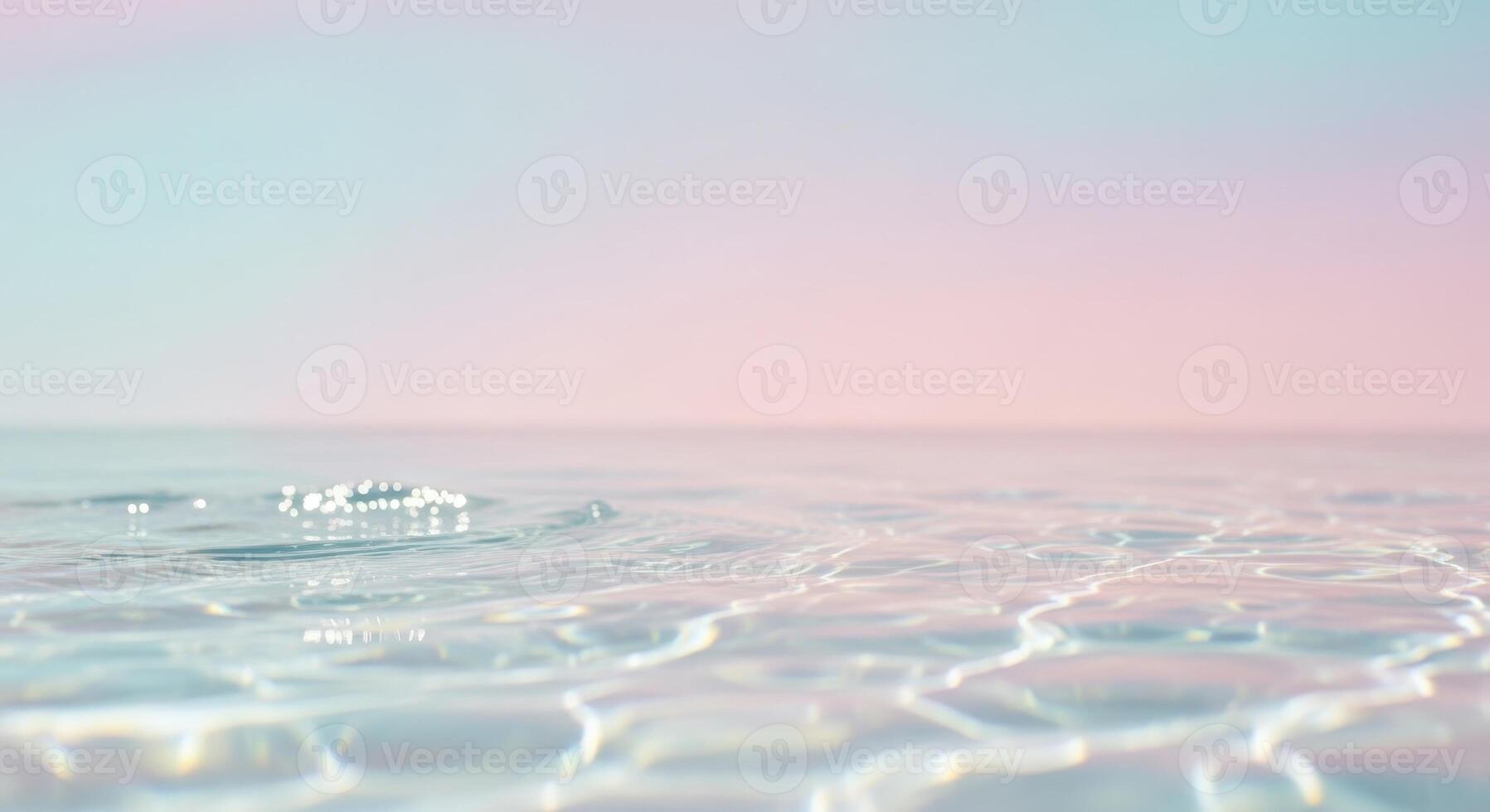The water surface ripples with a soft pink and blue background photo