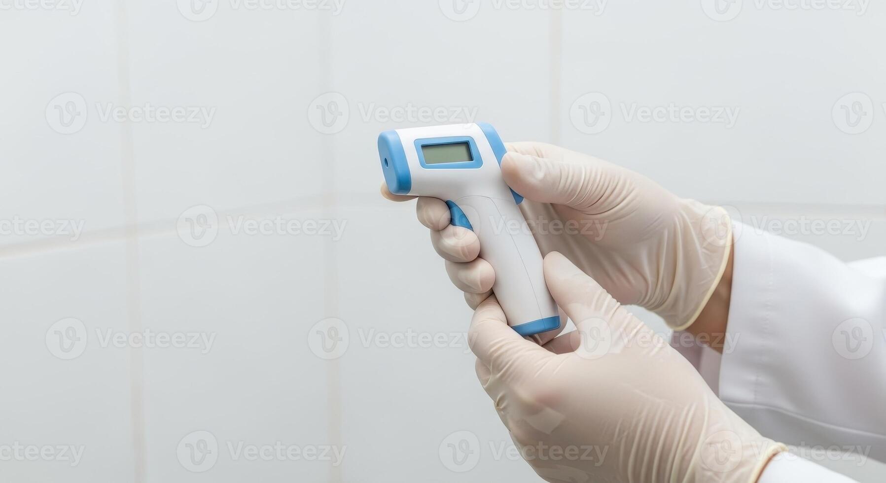Hand holding infrared thermometer for temperature check photo