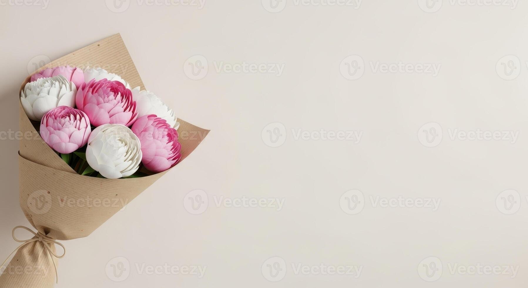 A charming bouquet of pink and white ranunculus wrapped in craft paper photo