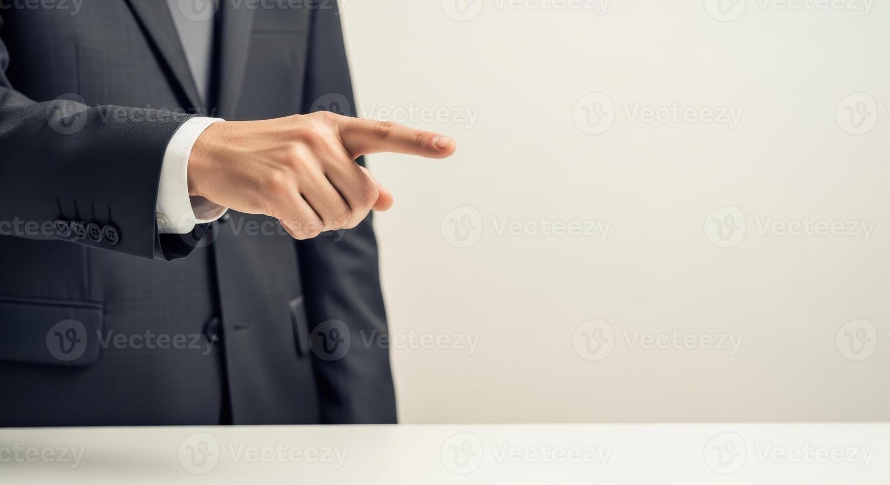 A businessman is pointing his finger towards the right side photo