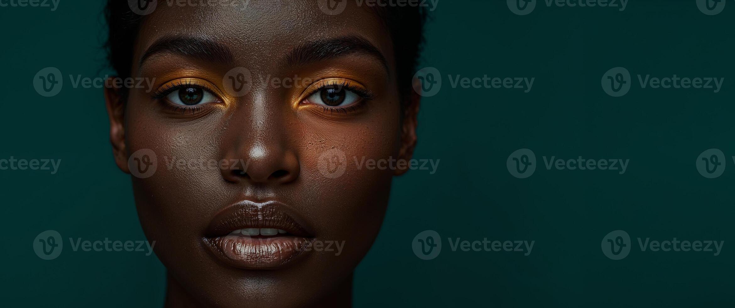 A woman with a bright yellow eye and dark skin photo
