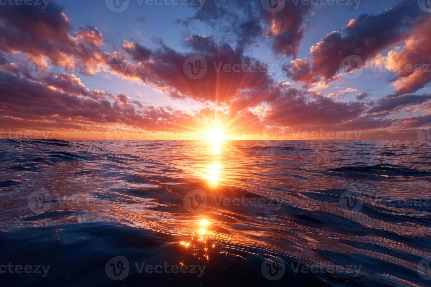Sunset over calm ocean waters with vibrant clouds reflecting warm colors photo