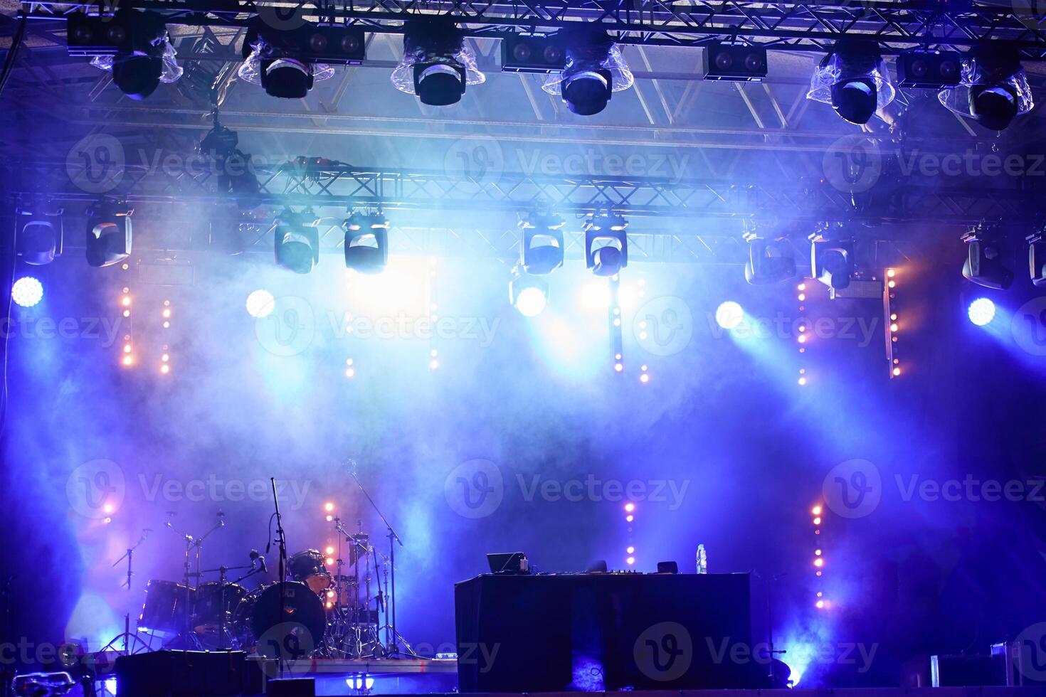 Empty stage with bright spotlights and smoke during live music concert photo