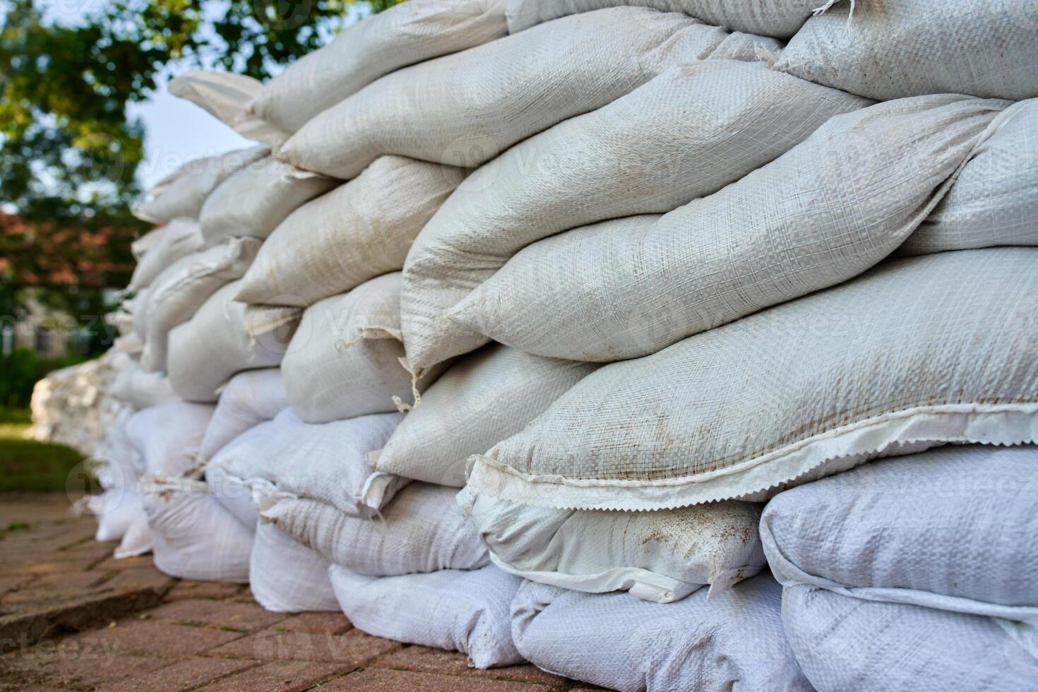 Flood prevention wall made of sandbags in city street photo