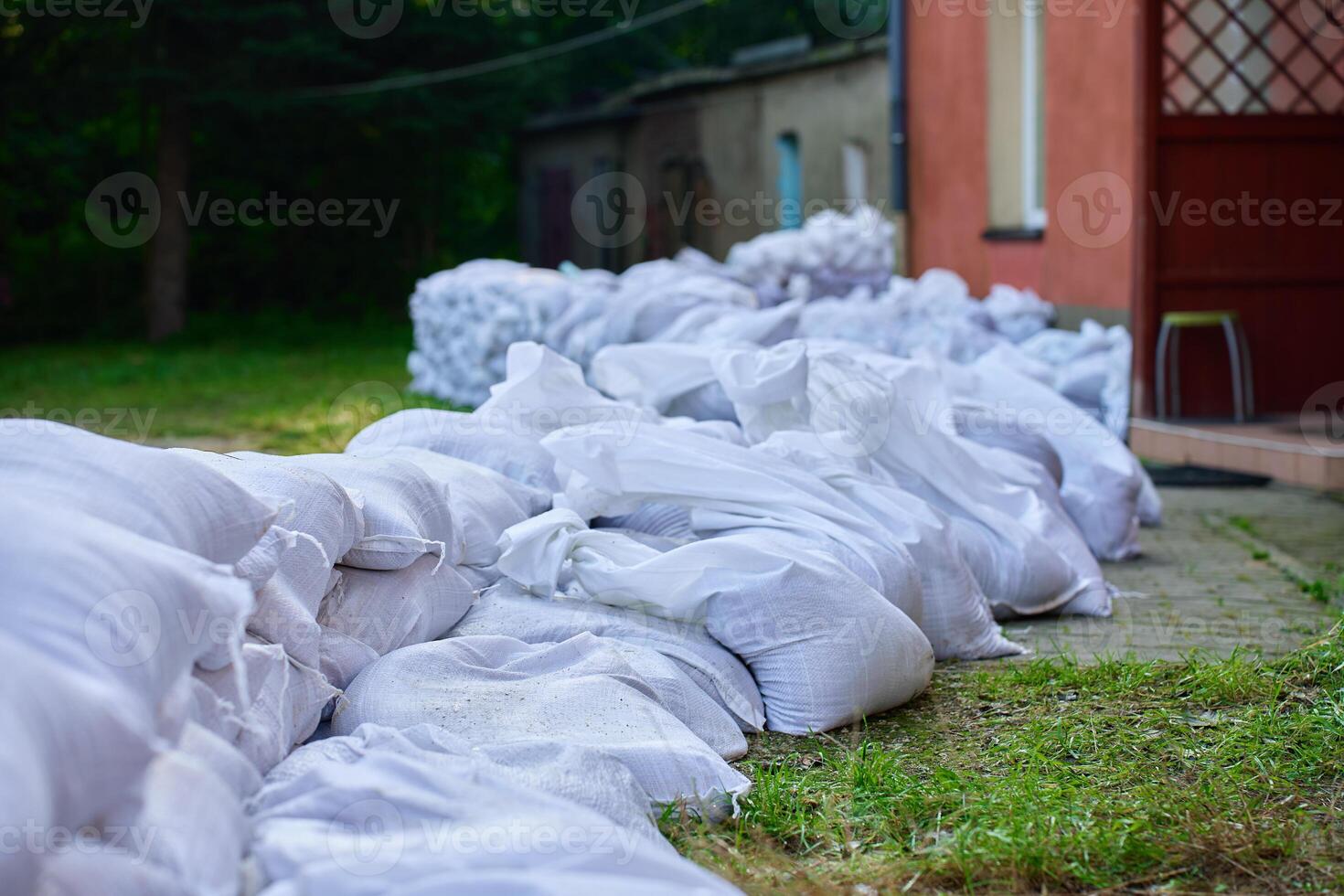 Sandbags stacked near house to protect from flood photo