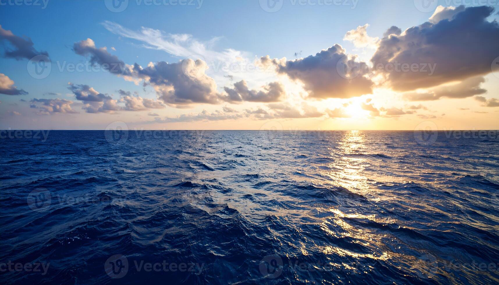 Dramatic sunset over a calm blue ocean. Sun setting on the horizon with clouds, reflecting on the sea. Peaceful seascape background for travel, meditation, or nature concepts. photo