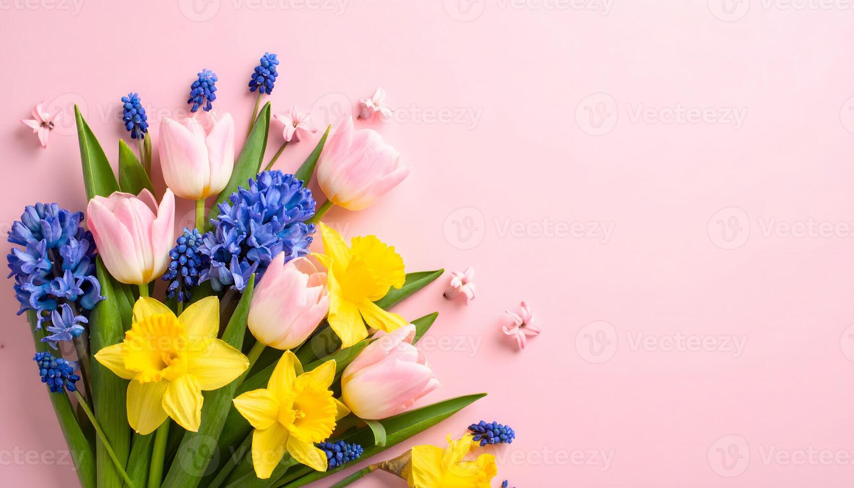 Beautiful bouquet of fresh spring flowers like tulips, daffodils, and hyacinths on a pink background. Colorful flat lay composition with copy space for Easter or Mother's Day greetings. photo