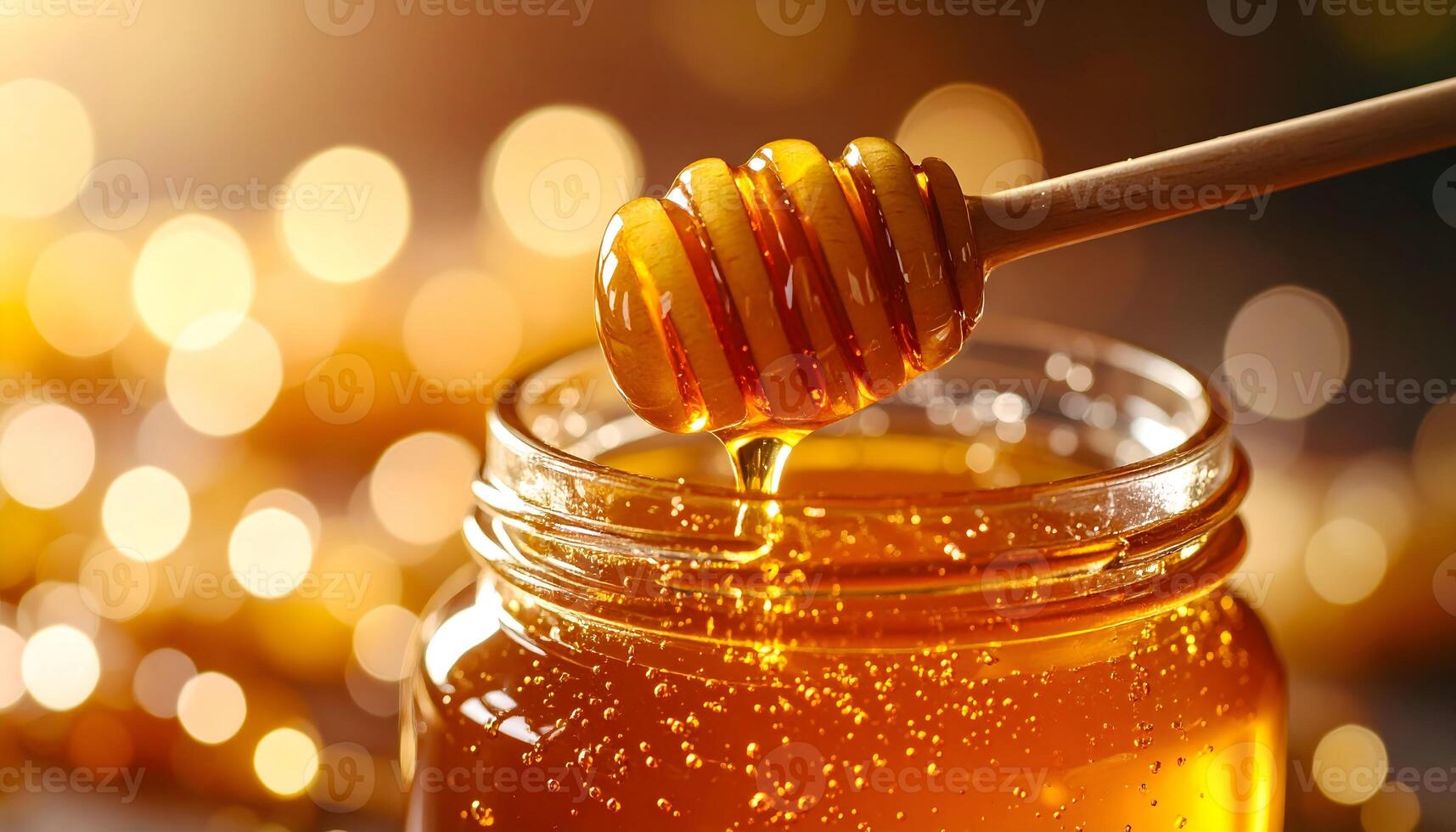 Honey in jar with wooden dipper photo