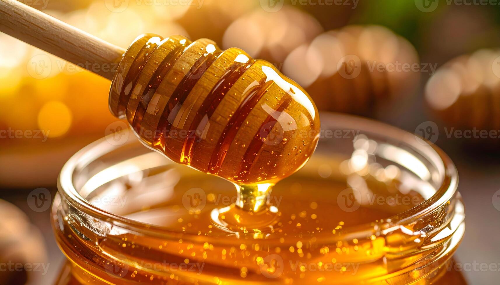 Honey dripping from wooden dipper photo