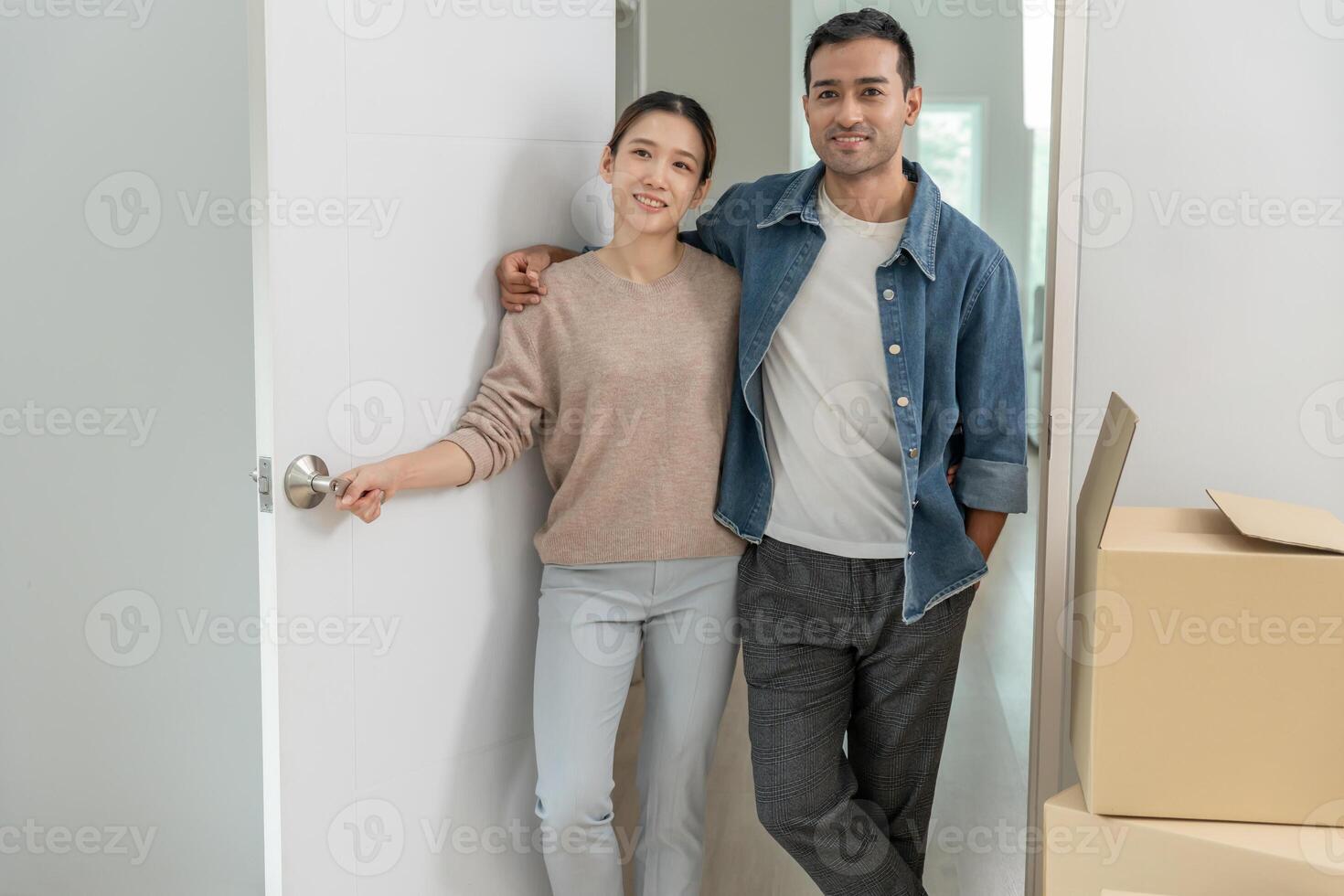 Moving house, relocation, Couple look in space room for furniture in new house, inside the room was a cardboard box contain personal belongings. move in the new apartment or condominium. photo