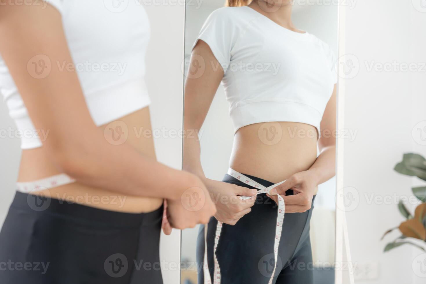 Women showing results of diet. Beautiful shape. female have a reduced waist size after under going a weight loss corse. can not wear jeans due to weight loss balance, control, routines photo