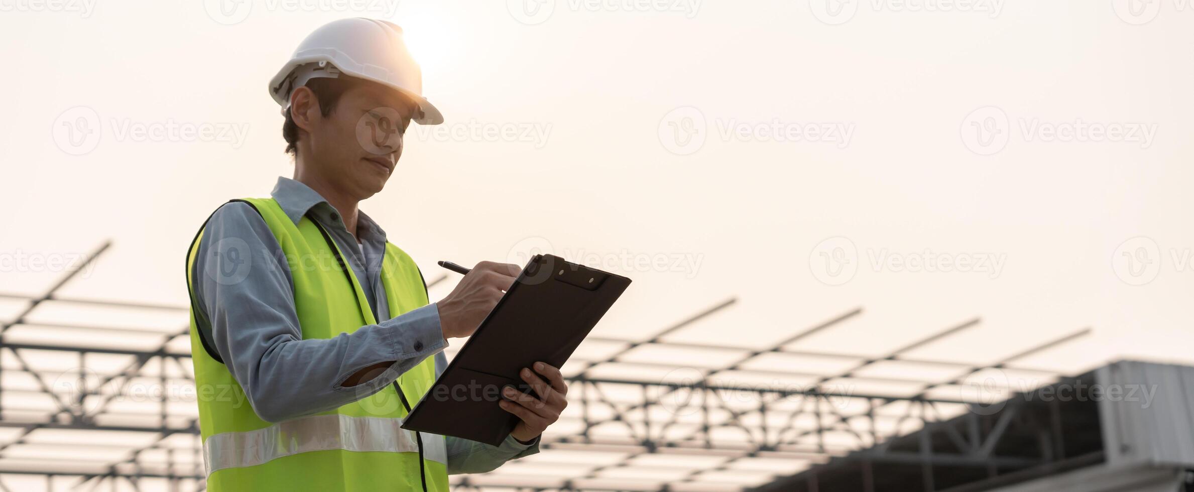 inspector or engineer is inspecting construction and quality assurance new house using a checklist. Engineers or architects or contactor work to build the house before handing over to the homeowner photo
