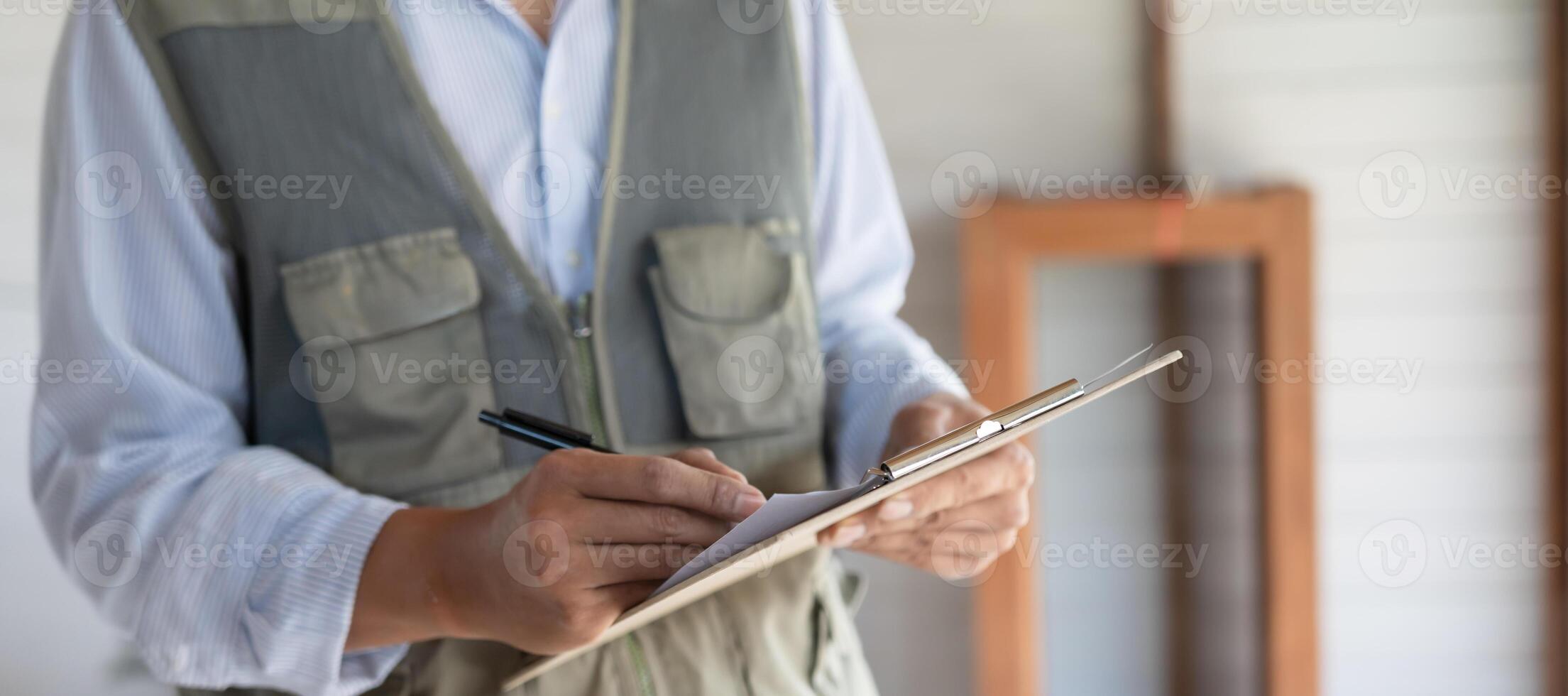 engineer is inspect construction and quality assurance new house using a checklist. Engineers or architects or contactor work to build the house before handing it over to the homeowner. photo