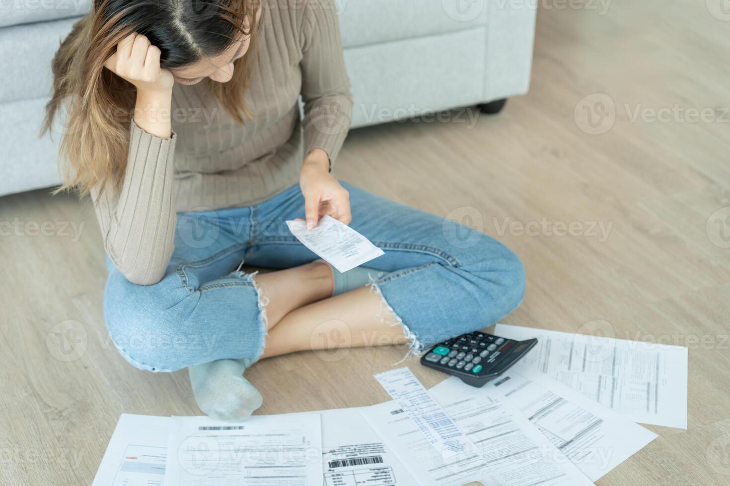 Stressed and headache asian woman with large bills or invoices no money to pay to expenses and credit card debt. shortage, Financial problems, mortgage, loan, bankruptcy, bankrupt, poor empty wallet. photo