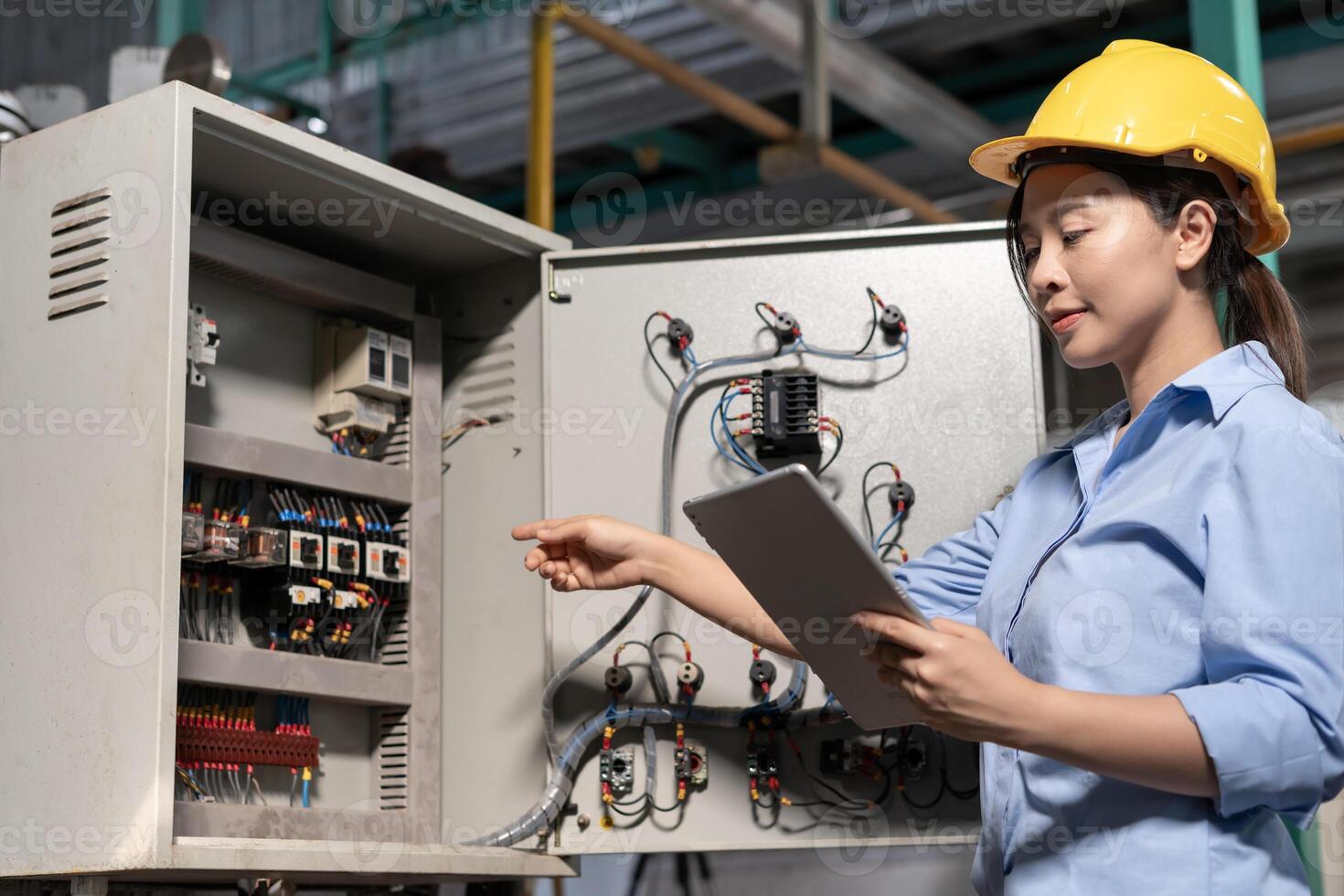 Mechanic or maintenance or electrical engineer checking main electrical control systems industrial plant. Utility fore man daily check power systems in process. Main Distribution Board, Switchboard photo