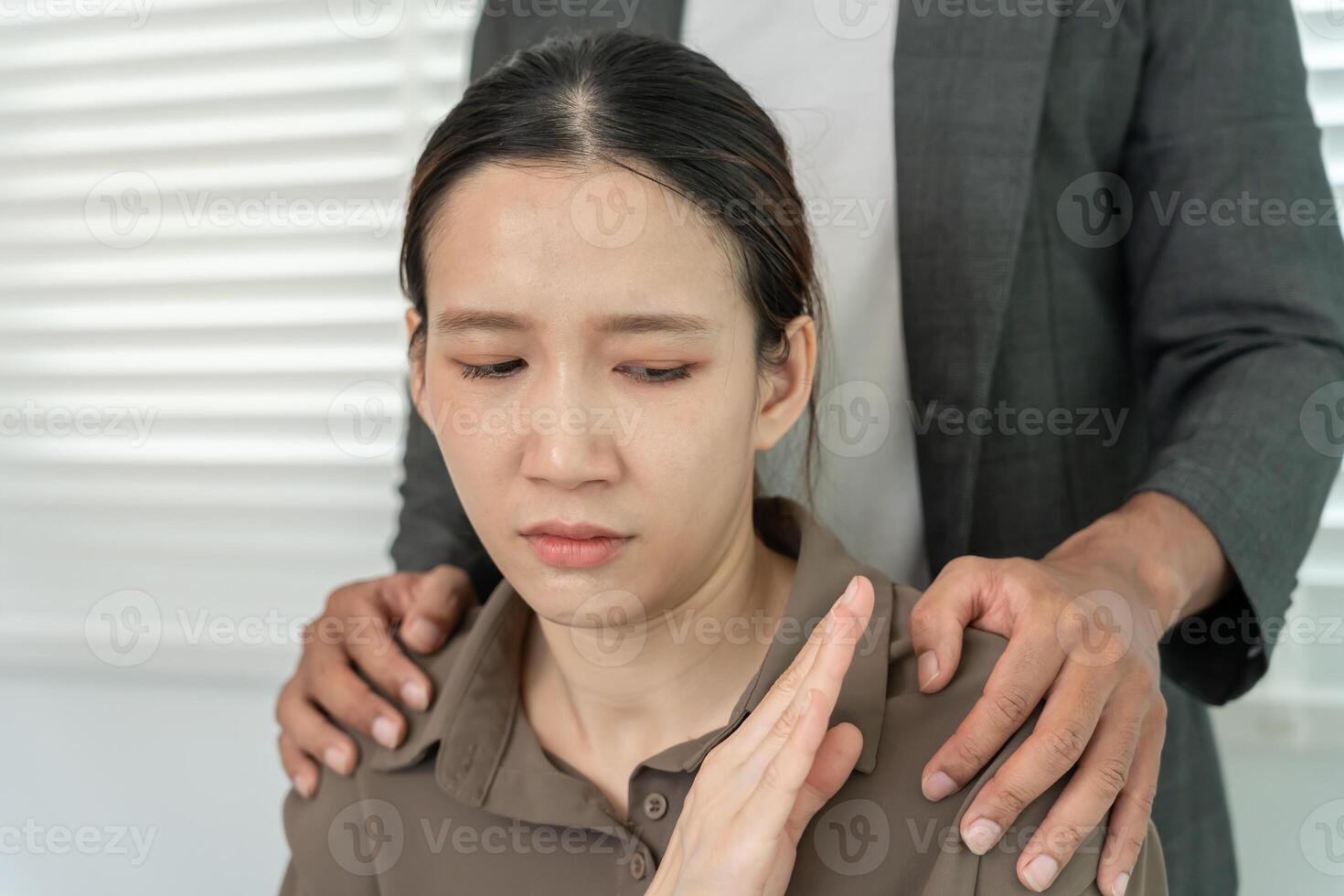 business man sexually harassed a female colleague by touch her shoulder. Sexual harassment in office. Women feel anxious and stressed from being harassed. molest, assault, inappropriate, photo