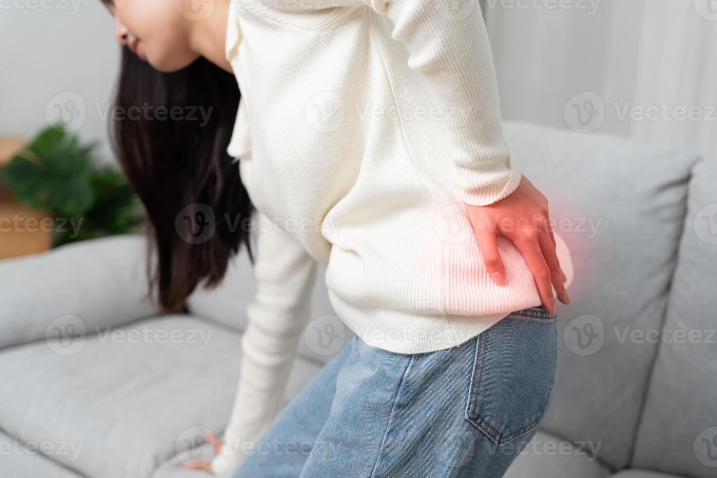 beautiful woman holding her lower back while and suffer from unbearable pain health and problems, chronic back pain, backache in office syndrome, scoliosis, herniated disc photo