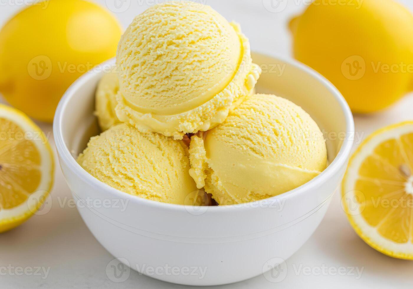 Close-up of a white bowl filled with three scoops of lemon ice cream, garnished with a mango slices photo