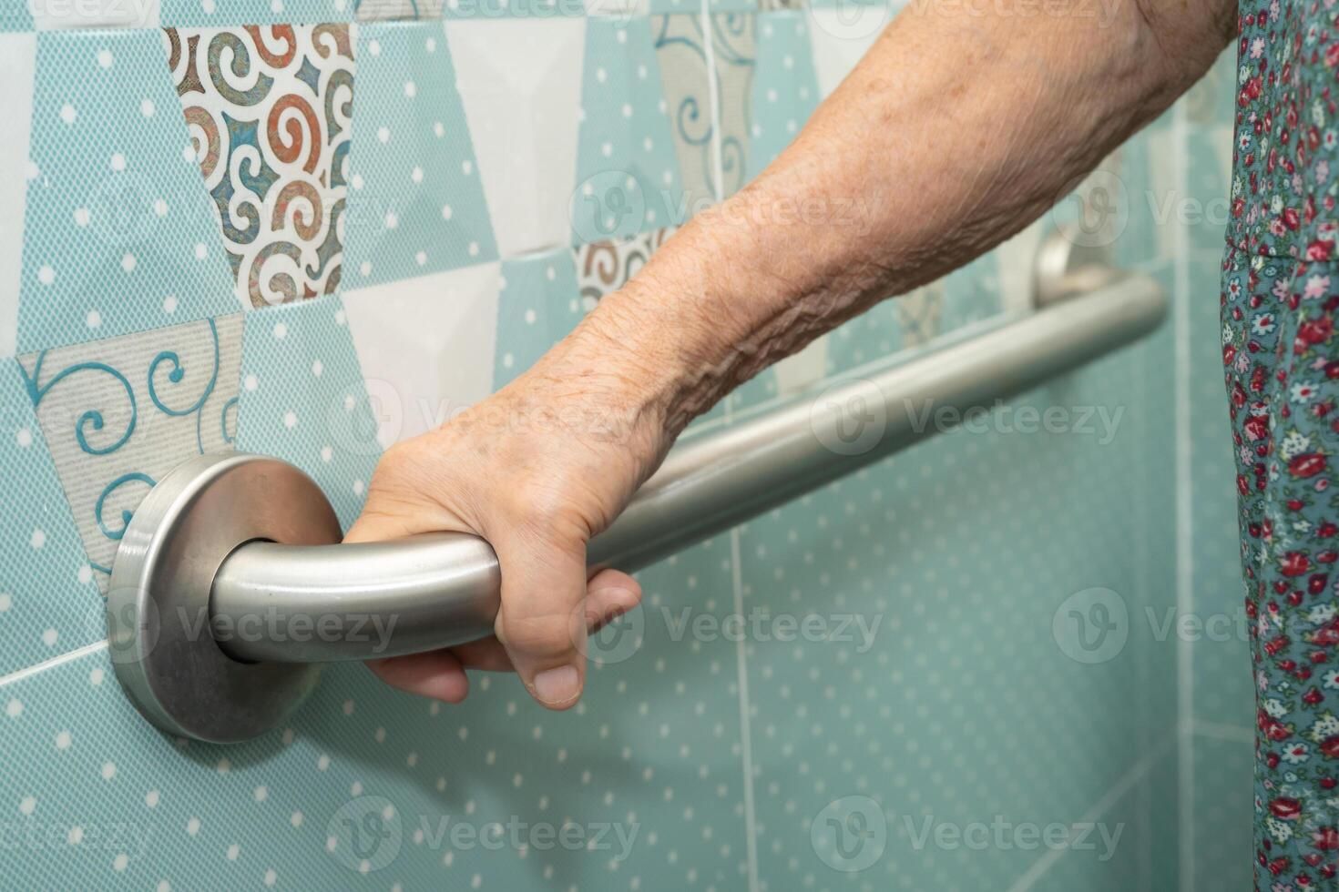 elderly woman patient use toilet bathroom handle security in nursing hospital, healthy medical. photo