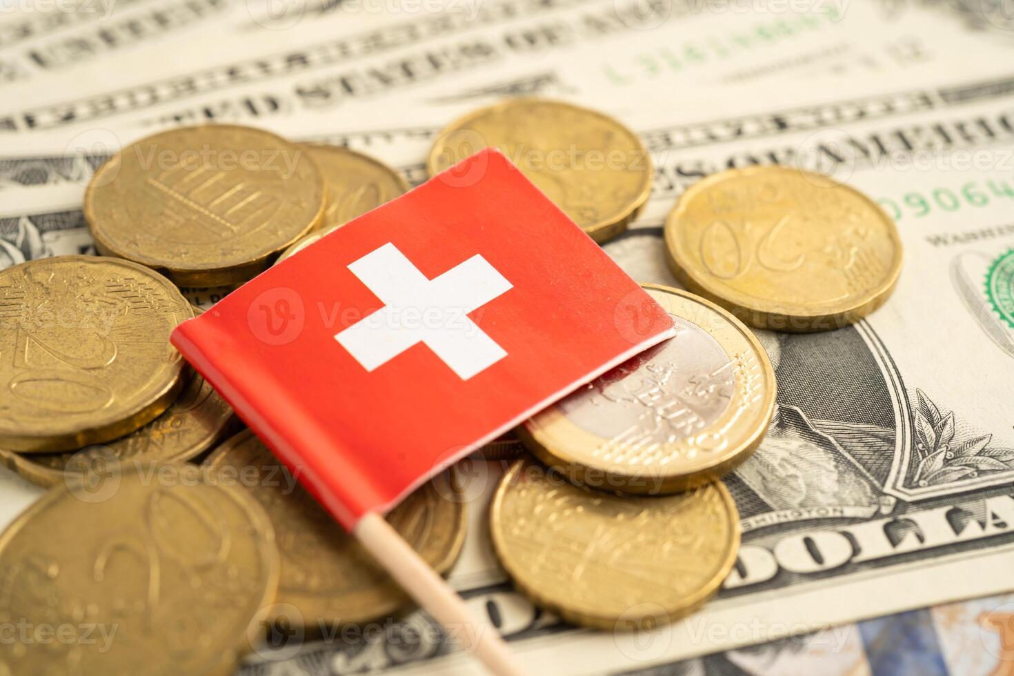 Stack coins with Switzerland flag and US dollar banknotes. photo