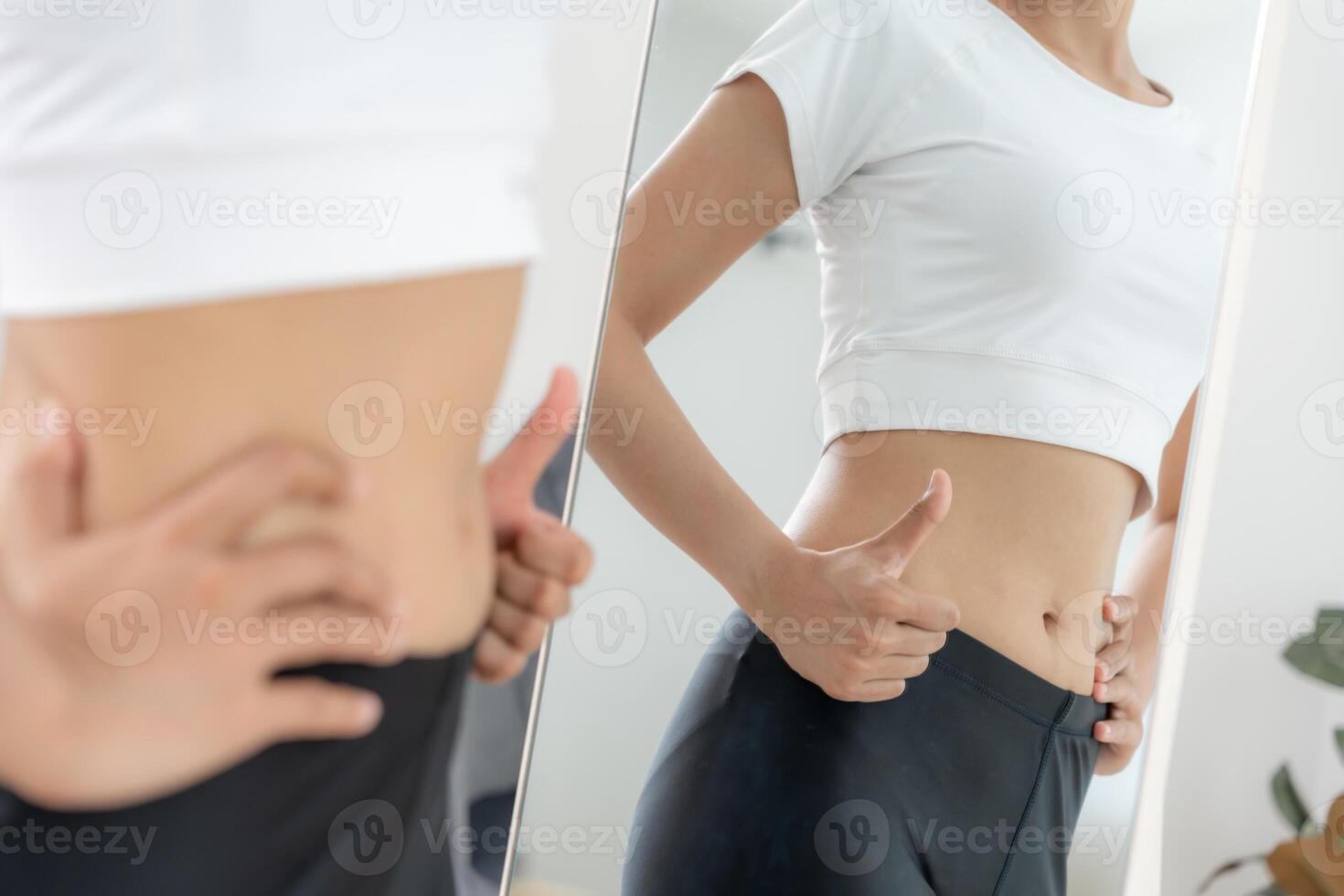 Women showing results of diet. Beautiful shape. female look mirror for check shape body have a reduced waist size after under going a weight loss corse. balance, control, routines, exercise photo