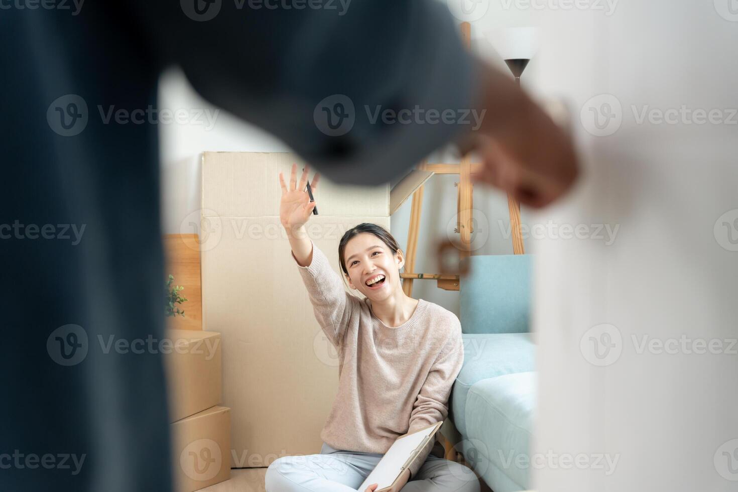 relocation. Open the door found wife smile and play on new house, inside the room was a cardboard box contain personal belongings and furniture. move in the new apartment or home. photo