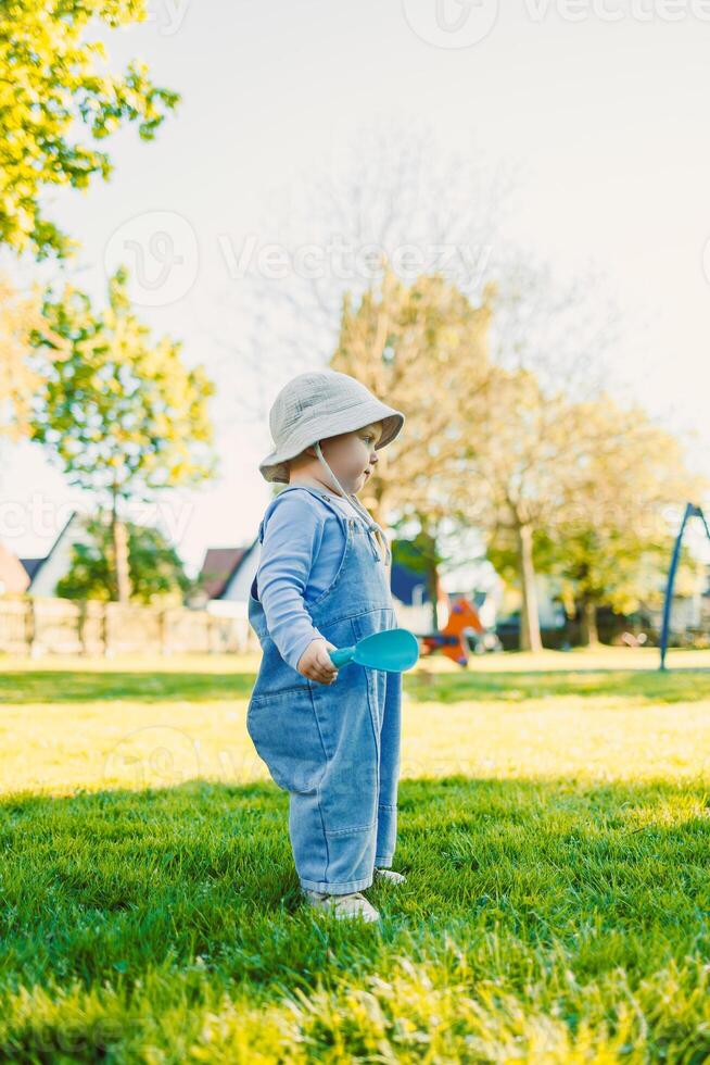 Adorable Toddler in a Park A Beautiful Moment of Pure Childhood Innocence Captured Under Bright and Clear Blue Skies, Surrounded by Lush Nature and the Joy of Playfulness and Adventure photo