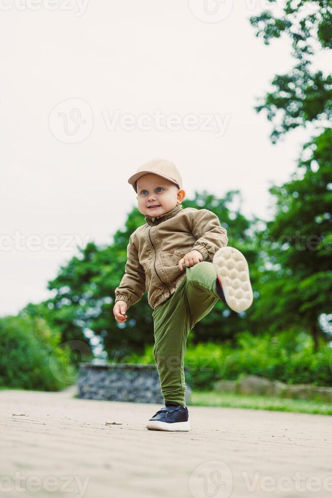 A Cheerful Child Joyfully Playing Outdoors in the Embrace of Nature Taking Happy Steps on an Adventure Filled with Excitement and Discovery, Exploring the World Around Him with Glee photo