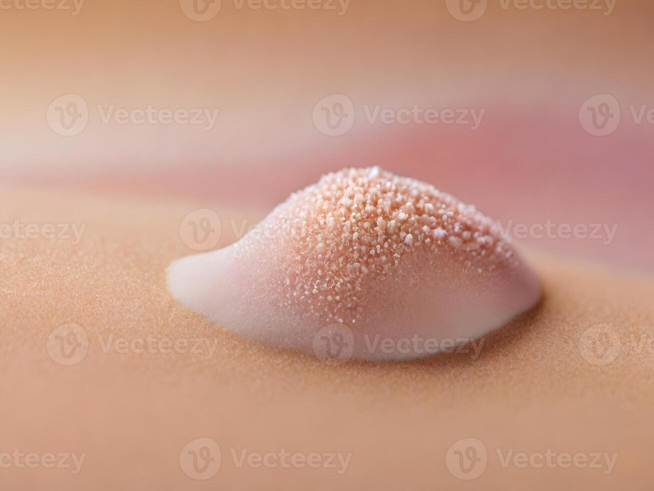 Close-up of a pink, textured substance on skin, with granular details. photo