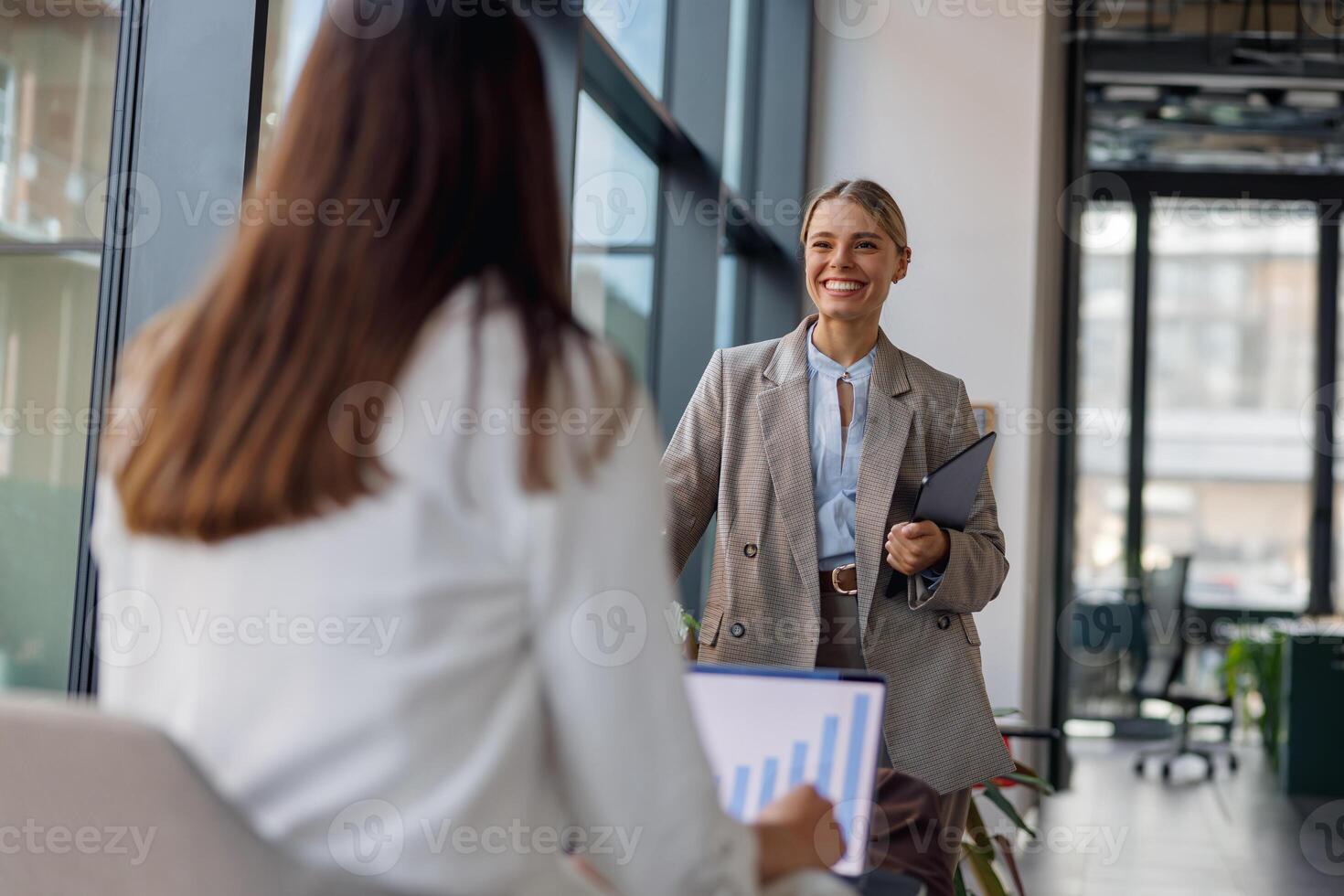 A Professional Business Meeting Happening with Smiling Colleagues in a Modern Office Environment photo