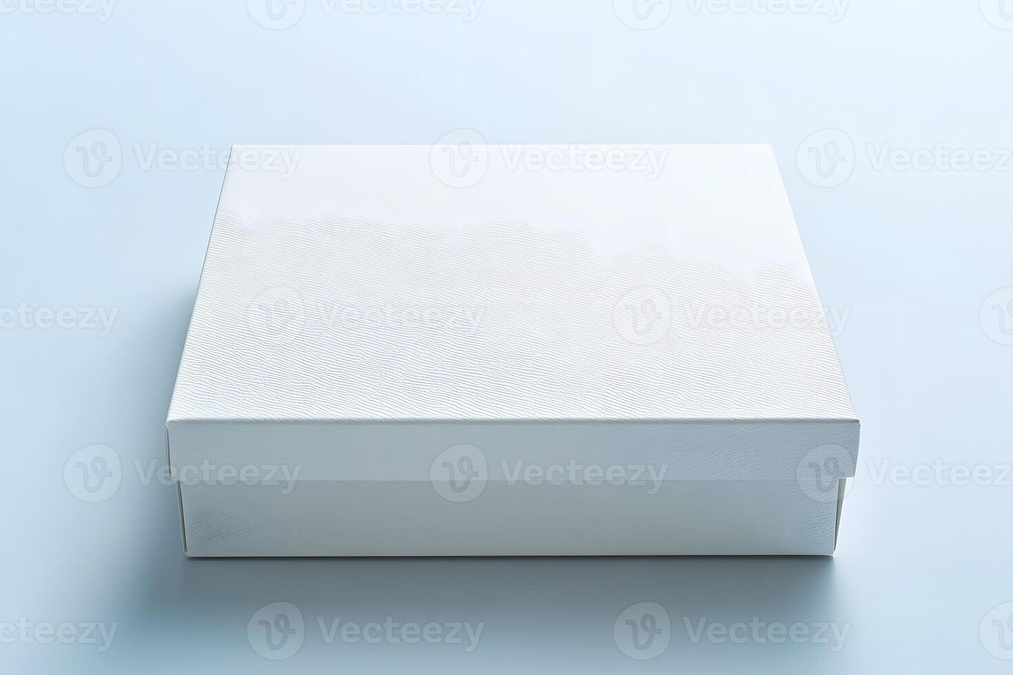 Pristine White Gift Box with Textured Lid on a Light Blue Surfac photo