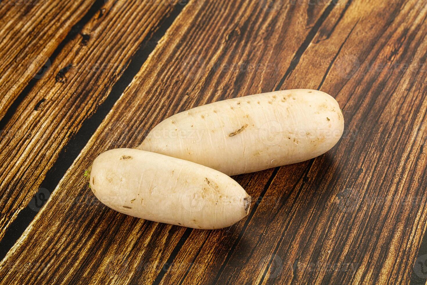 Two potatoes on a wooden table photo