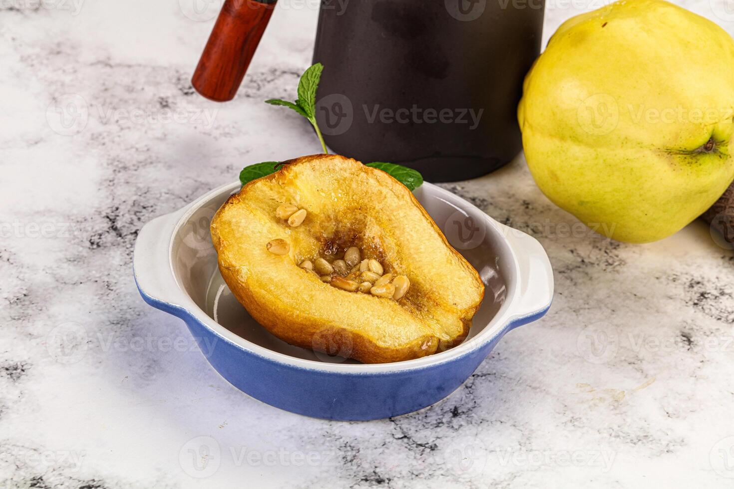 A bowl of fruit and a coffee pot on a table photo