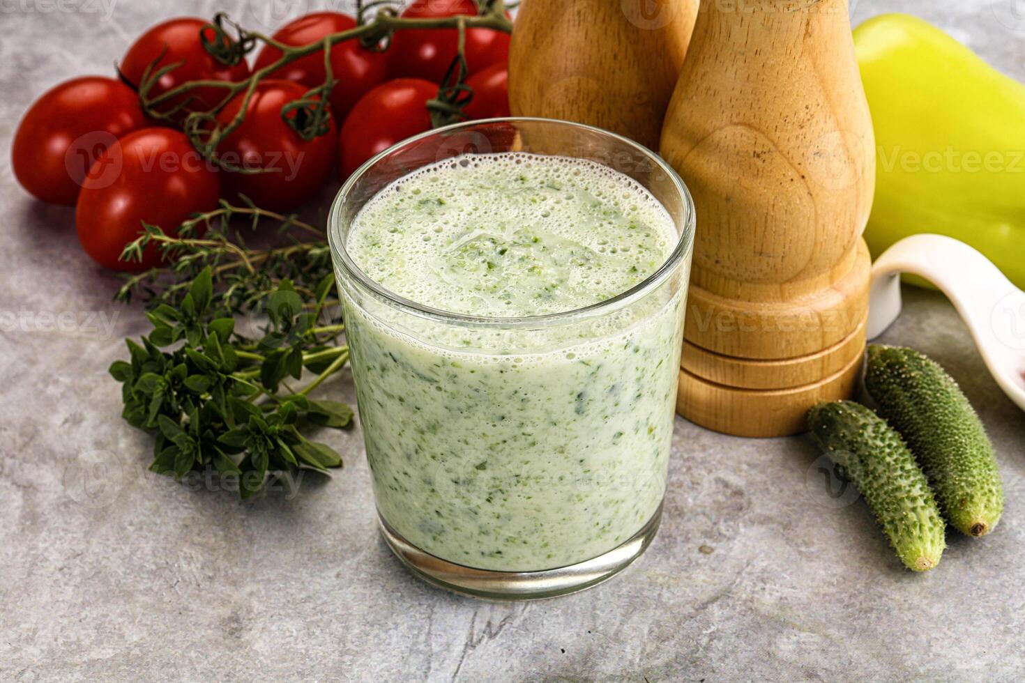 A glass of green smoothie with vegetables and spices photo