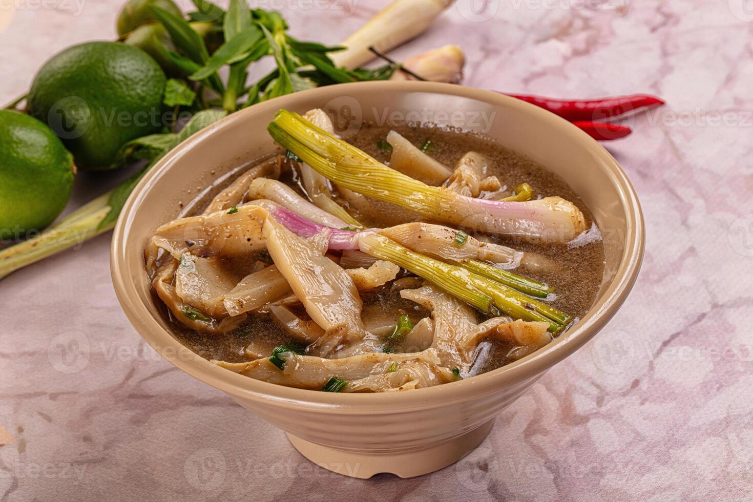 A bowl of soup with a green vegetable photo