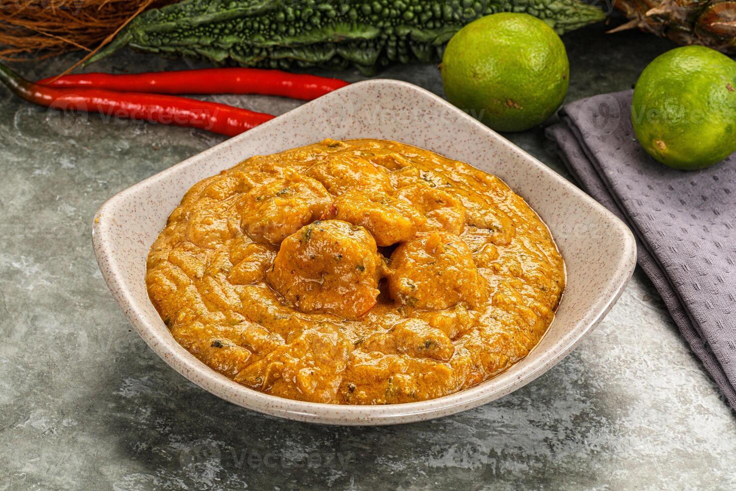 A bowl of sauce with some vegetables and spices photo