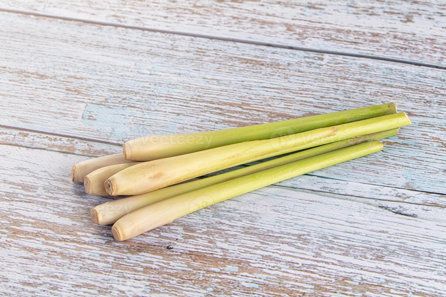 Three pieces of fresh green limes on a wooden table photo