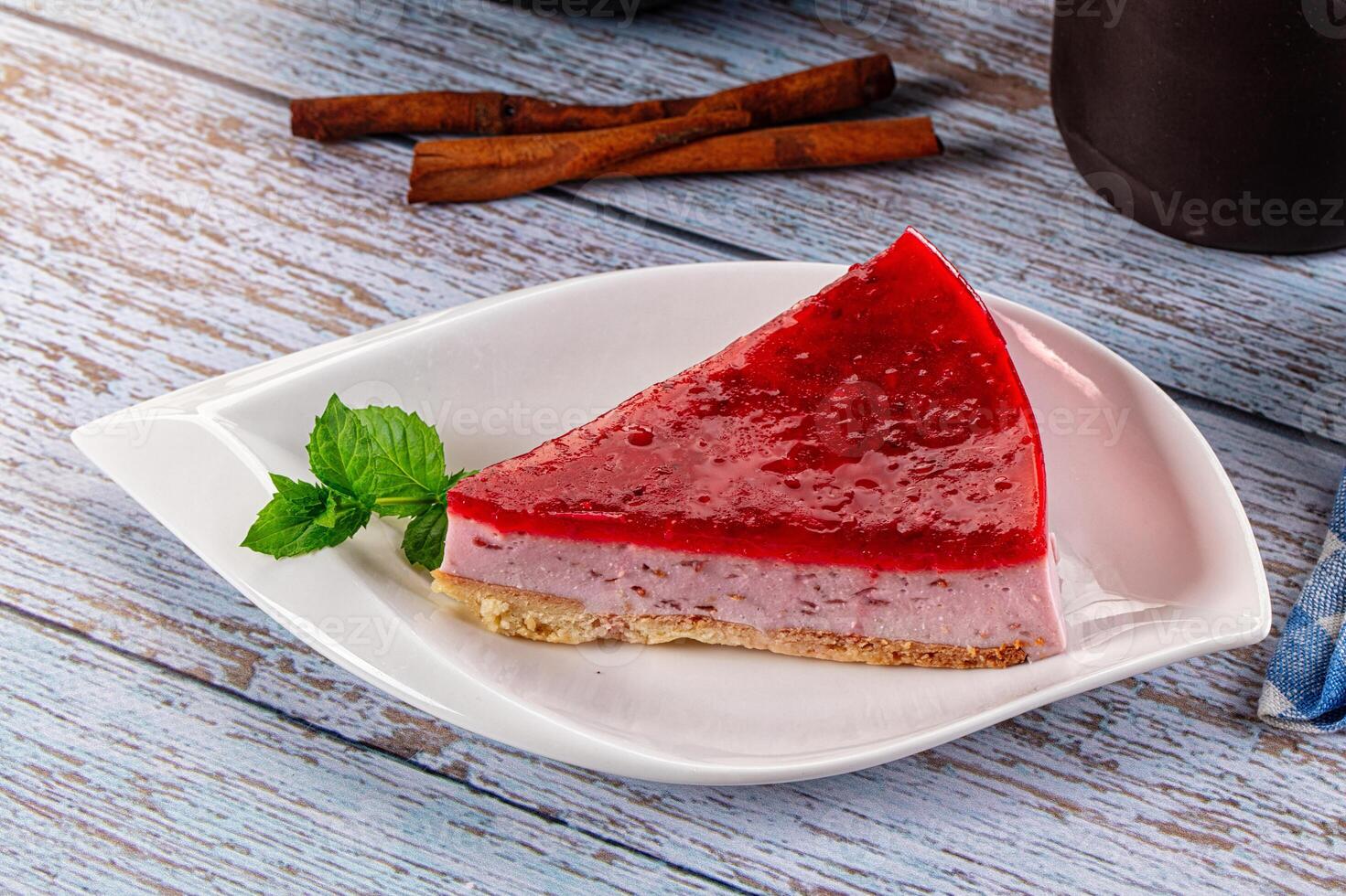 A piece of cake on a plate with a cup of coffee photo