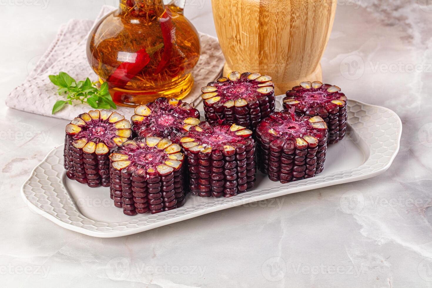 A plate with some corn on it and a glass of syrup photo
